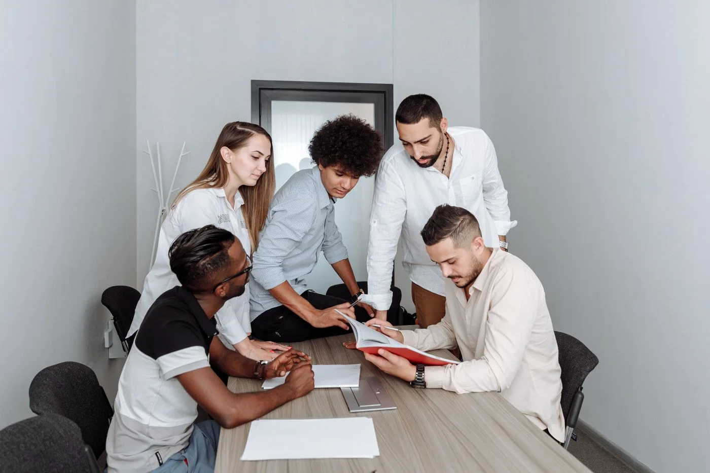 Professionals listening and sharing ideas around a meeting table